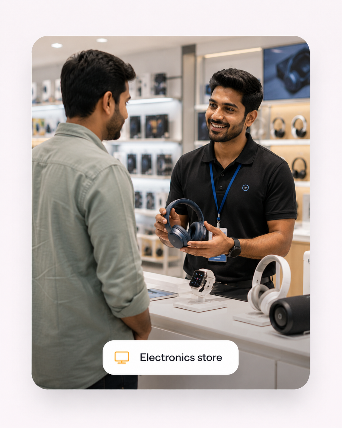 An electronics store employee speaking with a customer